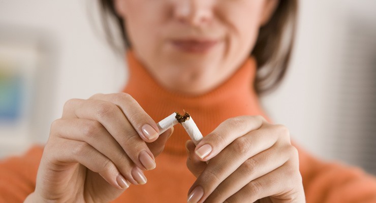 0070_86809664 image of woman breaking a cigarette