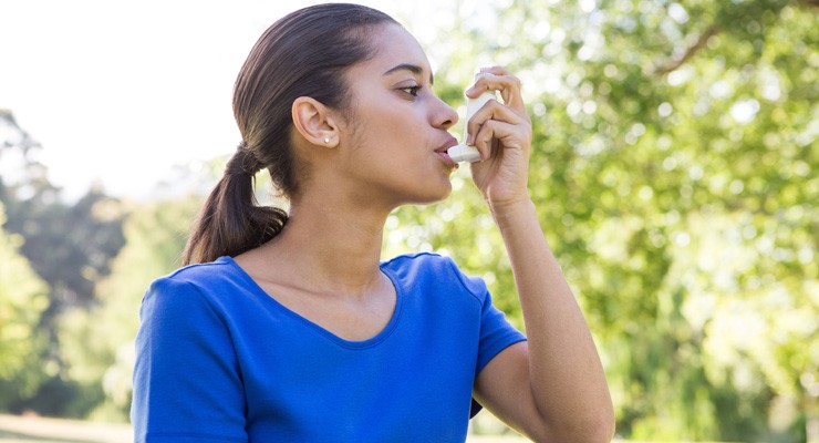 0106_474771466 woman using an asthma inhaler