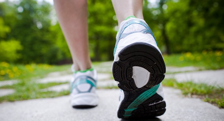 0115_Thinkstock_153173643 image of woman's lower legs in sneakers, walking away