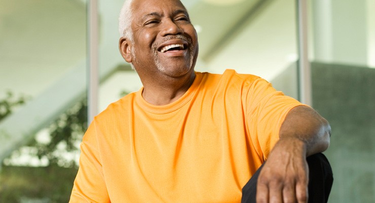0140_78811846 older man sitting on weight bench