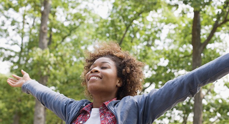 0283_80471546 woman outside with arms outstretched