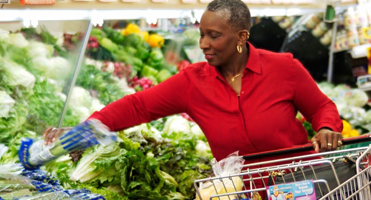 woman grocery shopping in produce aisle